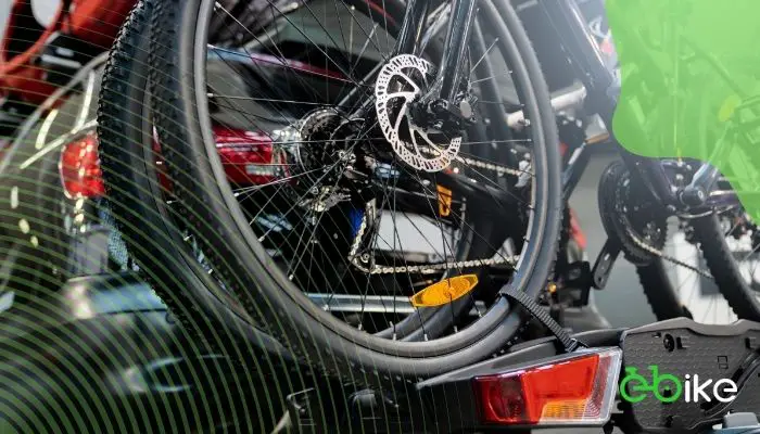 A robust heavy-duty fat tire bike rack securely mounted on a vehicle with a scenic background.